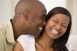 young black couple smiling and laughing dental crowns Nashua, NH